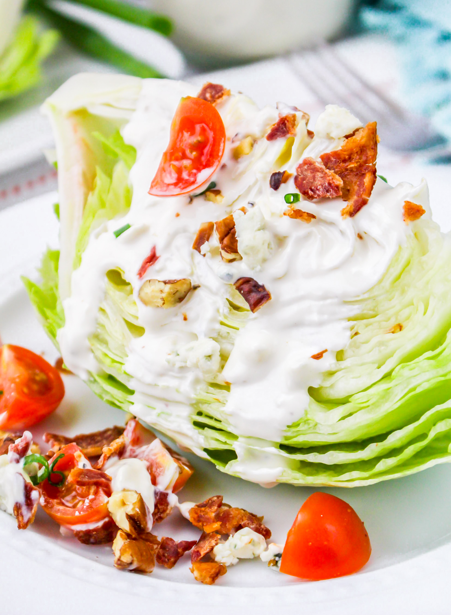 wedge of lettuce with dressing on plate