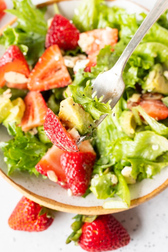 fork with strawberry avocado and lettuce